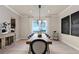 Dining room with wood table, modern lighting, and sophisticated black and white art at 2141 Weatherly Way, Orlando, FL 32820