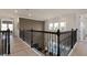 Second floor landing showcasing decorative railings, complemented by modern lighting fixtures at 2141 Weatherly Way, Orlando, FL 32820