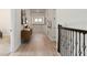 Bright hallway with light wood floors, complemented by decorative iron railings and stylish accents at 2141 Weatherly Way, Orlando, FL 32820