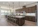 Spacious kitchen with a large island, modern lighting, and ample seating at 2141 Weatherly Way, Orlando, FL 32820
