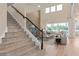 Open-concept living room with staircase and luxurious seating at 2141 Weatherly Way, Orlando, FL 32820