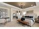 Spacious main bedroom with a seating area, stylish furnishings, and ample natural light at 2141 Weatherly Way, Orlando, FL 32820