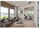 Comfortable sitting area with large windows, plush chairs, and a view into the serene bedroom at 2141 Weatherly Way, Orlando, FL 32820