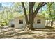 Backyard view featuring mature trees shading the house and yard at 2519 Poinsetta Ave, Sanford, FL 32773
