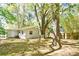 Spacious backyard featuring mature trees and green foliage surrounding the home at 2519 Poinsetta Ave, Sanford, FL 32773