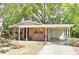 Charming brick home with a carport, beautiful landscaping, and a welcoming entrance at 2519 Poinsetta Ave, Sanford, FL 32773
