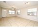 Large living space with tile floors, ceiling fan, and ample natural light from the many windows at 2519 Poinsetta Ave, Sanford, FL 32773