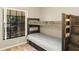 Cozy bedroom featuring a wooden bunk bed next to a window, offering a comfortable and stylish space at 2525 W Ponkan Rd, Apopka, FL 32712
