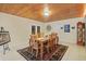 Traditional dining room with wood-paneled ceiling, seating for eight, and a decorative rug at 2525 W Ponkan Rd, Apopka, FL 32712