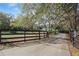 Long driveway leads to a gated property, offering privacy and a sense of seclusion at 2525 W Ponkan Rd, Apopka, FL 32712