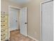 Hallway with multiple doors and a stylish dresser with a plush teddy bear, offering ample storage at 2525 W Ponkan Rd, Apopka, FL 32712