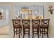 Kitchen island with bar-style seating looks into a connected kitchen with stainless appliances at 2525 W Ponkan Rd, Apopka, FL 32712
