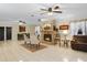 Inviting living room with a cozy stone fireplace, tile floors, and plenty of natural light at 2525 W Ponkan Rd, Apopka, FL 32712