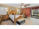 Cozy main bedroom with four-poster bed, brick accent wall, and access to the patio at 2525 W Ponkan Rd, Apopka, FL 32712