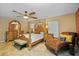 Inviting main bedroom with a four-poster bed, a brick wall, and a lounger at 2525 W Ponkan Rd, Apopka, FL 32712