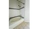 White bathtub with shower, with light beige tiled flooring at 3428 Soho St # 308, Orlando, FL 32835