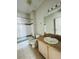 Neutral bathroom featuring a shower-tub combination and vanity with ample counter space, and neutral tile flooring at 3428 Soho St # 308, Orlando, FL 32835