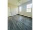 Bedroom with two windows and gray wood-look flooring at 3428 Soho St # 308, Orlando, FL 32835