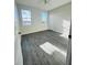 Bedroom with two windows and gray wood-look flooring at 3428 Soho St # 308, Orlando, FL 32835