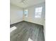 Bedroom with two windows and gray wood-look flooring at 3428 Soho St # 308, Orlando, FL 32835
