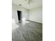 Spacious bedroom with gray wood-look flooring and ceiling fan at 3428 Soho St # 308, Orlando, FL 32835
