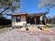 View of backyard with covered patio, exterior of house, and an outdoor grill at 3522 Wd Judge Dr, Orlando, FL 32808
