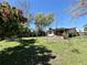 Expansive backyard featuring lush greenery, mature trees, and the back of the house at 3522 Wd Judge Dr, Orlando, FL 32808