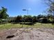 Spacious backyard with green grass, several trees, and a storage shed perfect for outdoor activities at 3522 Wd Judge Dr, Orlando, FL 32808