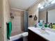 Tiled bathroom featuring neutral colors, framed mirror, single vanity and shower with curtain at 3522 Wd Judge Dr, Orlando, FL 32808