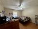 Inviting bedroom featuring wood-look floors, ceiling fan, and natural light from a window at 3522 Wd Judge Dr, Orlando, FL 32808