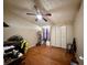 A bright bedroom with wood floors, ceiling fan, and closet at 3522 Wd Judge Dr, Orlando, FL 32808