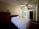 Cozy bedroom features a ceiling fan, wood floors, and access to the bathroom and closet at 3522 Wd Judge Dr, Orlando, FL 32808