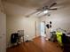 A bedroom with wood floors, ceiling fan, and a door that leads to the bathroom at 3522 Wd Judge Dr, Orlando, FL 32808