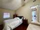 Bedroom features a large bed, wood floors, and access to the laundry area at 3522 Wd Judge Dr, Orlando, FL 32808
