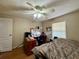 Cozy bedroom featuring hardwood floors, a ceiling fan, and natural light from a window at 3522 Wd Judge Dr, Orlando, FL 32808
