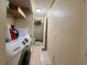 Functional laundry room with washer, dryer, and built-in shelves for storage at 3522 Wd Judge Dr, Orlando, FL 32808
