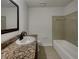 Clean bathroom featuring a granite countertop and shower over tub at 3646 Dovetail S Ln, Lakeland, FL 33812