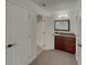 Bathroom with a granite vanity, framed mirror, and walk-in shower at 3646 Dovetail S Ln, Lakeland, FL 33812