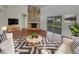 Inviting living room with stone fireplace, wood floors, and sliding glass doors at 3646 Dovetail S Ln, Lakeland, FL 33812