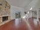 Spacious living room featuring a stone fireplace, vaulted ceilings, and sliding glass doors at 3646 Dovetail S Ln, Lakeland, FL 33812