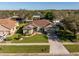 Aerial view of a beautifully landscaped home in a quiet suburban neighborhood at 3696 Peacepipe Ct, Clermont, FL 34711