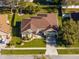 Aerial view of a meticulously maintained property showcasing the roof and landscaping at 3696 Peacepipe Ct, Clermont, FL 34711