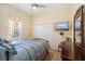 Bedroom with ceiling fan, a double closet and a mounted television at 3696 Peacepipe Ct, Clermont, FL 34711