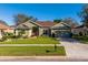Charming single-story home with well-manicured lawn, mature landscaping, and inviting curb appeal at 3696 Peacepipe Ct, Clermont, FL 34711