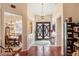 Inviting foyer with hardwood floors, chandelier, and decorative double doors leading to dining area at 3696 Peacepipe Ct, Clermont, FL 34711
