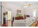 Open-concept living room featuring hardwood floors, fireplace, and comfortable sectional at 3696 Peacepipe Ct, Clermont, FL 34711