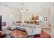 Spacious living room with a ceiling fan, hardwood floors and a cozy sectional couch at 3696 Peacepipe Ct, Clermont, FL 34711