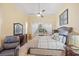 Main bedroom with ceiling fan, window and curtains, and dresser at 3696 Peacepipe Ct, Clermont, FL 34711