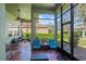 Enclosed patio with tile floor, ample seating, and views of the beautiful backyard at 3696 Peacepipe Ct, Clermont, FL 34711