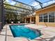 Screened-in pool area with a sparkling pool, patio furniture and view of home's exterior and windows at 3850 Eagle Isle Cir, Kissimmee, FL 34746